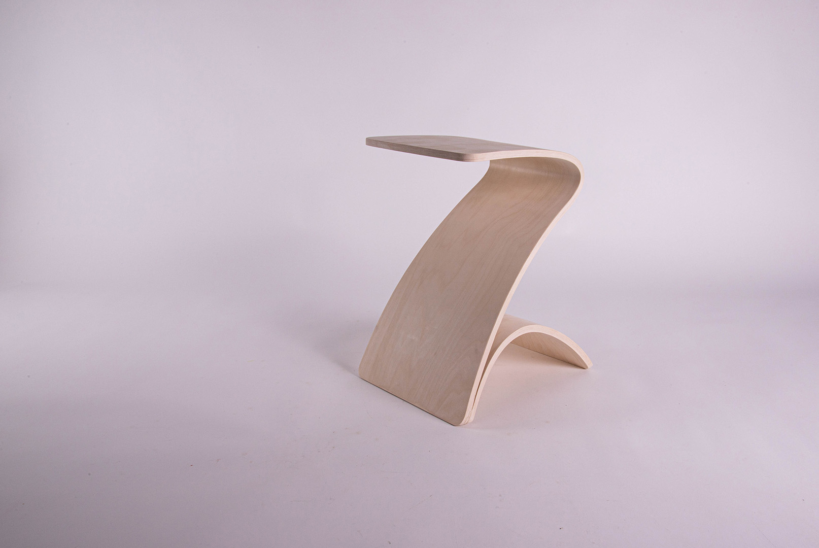 Elegant, plywood stool in a studio