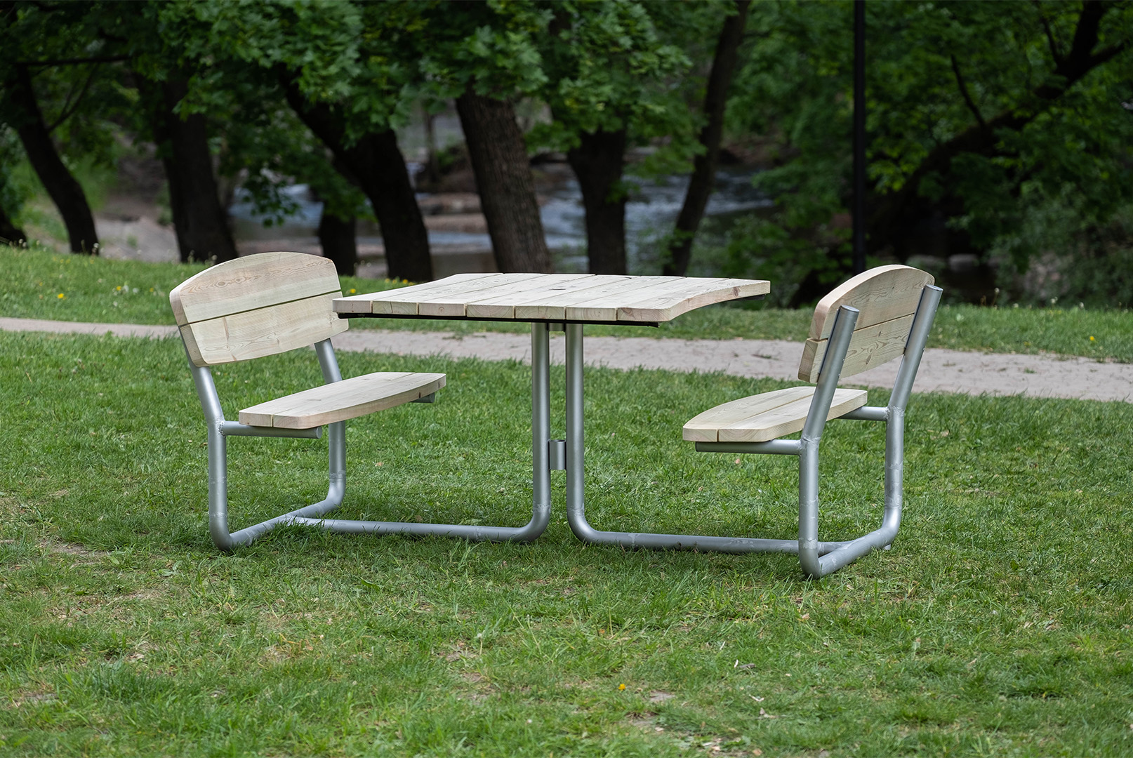 Picnic table stadning by itself on the grass